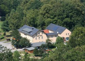 an aerial view of a hotel in the middle of a forest at Hotel Garni Neue Schänke in Königstein an der Elbe