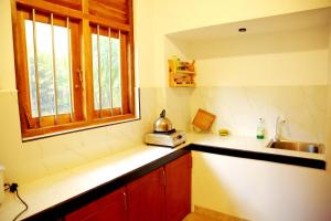 a kitchen with a sink and a counter top at Hiriketiya Suka Place in Hiriketiya