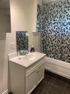 a bathroom with a sink and a shower curtain at Chalet Ski Mont Calm Water Falls River Rawdon in Rawdon