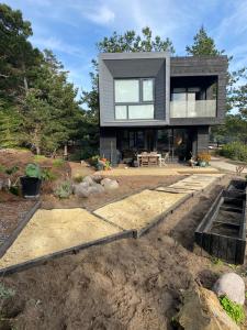 a house being built on a hill with trees at Calm and beautiful beach in Pichilemu