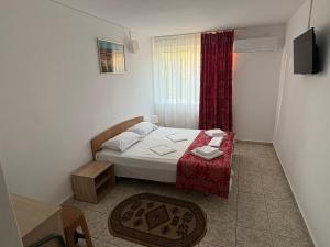 Ένα ή περισσότερα κρεβάτια σε δωμάτιο στο Hotel Camelia