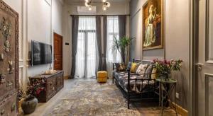 a living room with a couch and a television at Origin Antique House and Hotel in Guangzhou