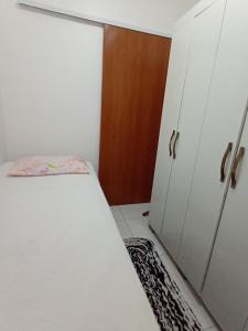 a small bedroom with a bed and a closet at Casa Pajuçara in Maceió