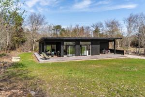 a black house in the middle of a field at LF302-Hurup-Helligsovej-2-F in Hurup