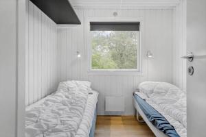 a bedroom with two beds and a window at LF160-Vestervig-Gunhildsvej-60 in Vestervig +33 photos