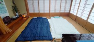a large blue bed in a room with windows at Kanupata - Vacation STAY 18611 in Ishigaki Island