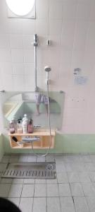 a child standing in a shower in a bathroom at Kanupata - Vacation STAY 18611 in Ishigaki Island