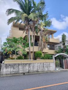 a building with palm trees in front of it at Kanupata - Vacation STAY 18611 in Ishigaki Island