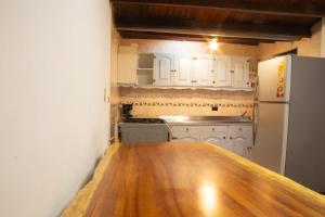 a kitchen with a wooden counter top and a refrigerator at Jungle House Medellin in Medellín