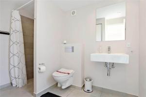a white bathroom with a toilet and a sink at LF299-Vestervig-Ingersvej-21 in Vestervig +13 photos