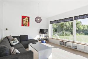 a living room with a couch and two windows at LF299-Vestervig-Ingersvej-21 in Vestervig