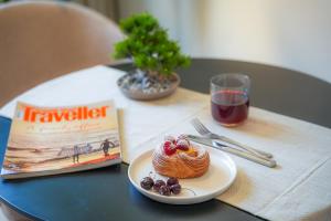 a table with a plate of food and a book at LIV by Yamama - KAFD in Riyadh +20 photos