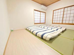 a row of pillows on the floor in a room at Sweet House Sugamo 101 in Tokyo