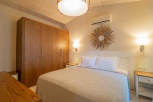 a bedroom with a large bed with white pillows at Akdeniz Bahçesi Apart Hotel by Kimera Lounge in Cıralı