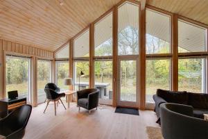 una sala de estar con muchas ventanas de cristal en 1441-Aakirkeby-Strandparken-14, en Vester Sømarken