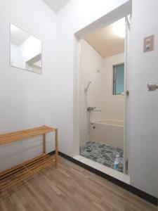 a bathroom with a shower and a tub and a mirror at Cate no mori - Vacation STAY 20958v in Shime +3 photos