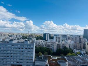 a view of a city with tall buildings at Appartement stunning view Paris in Courbevoie