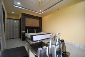 a bedroom with a bed and a bottle of champagne at Hotel O Prince Residency in Bhubaneshwar
