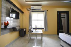 a living room with a table and a window at Hotel O Prince Residency in Bhubaneshwar