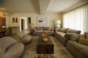a living room with a couch and a table at Mediterranean Seasons Sensation Villa in San Vicente del Raspeig