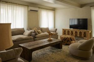 a living room with a couch and a tv at Mediterranean Seasons Sensation Villa in San Vicente del Raspeig