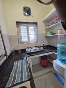 a kitchen with a stove and a counter top at Saptagiri elite 104 in Kondapur