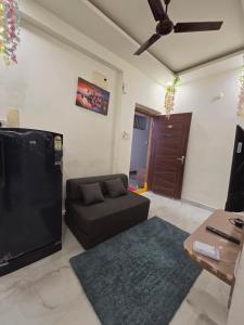 a living room with a couch and a tv at Saptagiri elite 104 in Kondapur