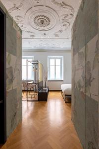 a living room with a bed and a ceiling at Casa Trentini 2 - Atemporary Art Apartments in Trento