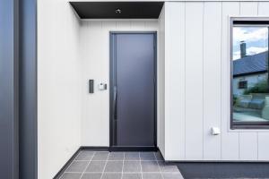 a door in a white building with a window at S suzukou in Asahikawa