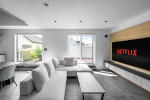a living room with a couch and a television at S suzukou in Asahikawa +128 photos