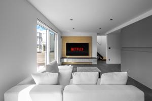 a living room with a white couch and a tv at S suzukou in Asahikawa