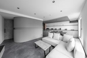 a living room with a white couch and a table at S suzukou in Asahikawa