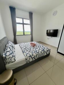 a bedroom with a bed and a window and a television at Appartment Desaru Utama in Bandar Penawar +19 photos
