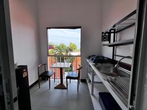 a kitchen with a window and a sink and a table at Ko Lipe Appartamenti in Satun