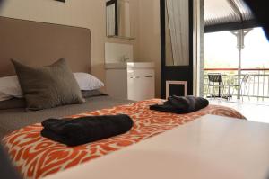 a bedroom with a bed with two towels on it at Royal Gatton Hotel in Gatton