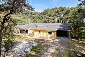 a cabin in the woods with a deck at 2726-Nexo-Fjaelstaunijn-14 in Vester Sømarken