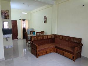 a living room with a couch and a table at Godiva apartment in Cochin