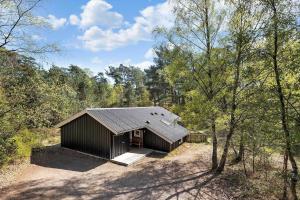 a small building in the middle of a forest at 2722-Nexo-Jaegerstien-6 in Neksø