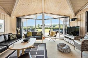 a living room with a couch and a table at OH287-Hadsund-Haslevgarde-Eng-1 in Hadsund