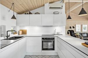 a white kitchen with white cabinets and a sink at OH287-Hadsund-Haslevgarde-Eng-1 in Hadsund