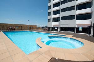 a large swimming pool in front of a building at Park Regis North Quay in Brisbane