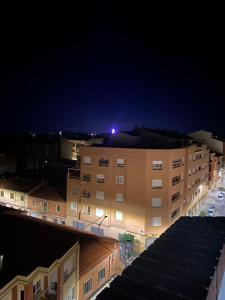 a building with a light on top of it at night at Ático con Terraza Feria Albacete in Albacete