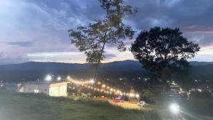 a group of lights on a hill at night at ภูโอบตะวันรีสอร์ต - Phu Oab Tawan Resort in Nan