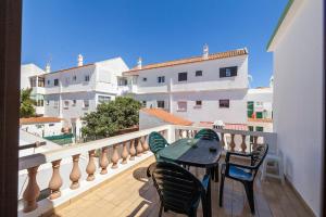 a patio with a table and chairs on a balcony at Bairro Apartment in Lagos in Lagos