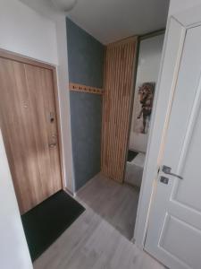 an empty room with a door and a closet at Blue apartment in Šiauliai
