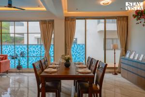 a dining room with a table and chairs at StayVista at Mount Brook with Mountain views, AC, Lawn in Igatpuri