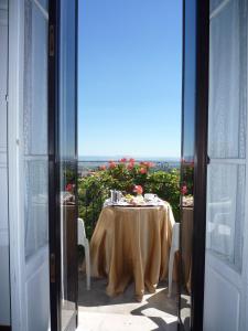 a table on a balcony with a view of the ocean at Albergo Il Marzocco dal 1860 in Montepulciano