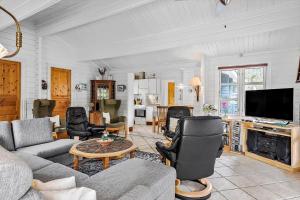 a living room with a couch and chairs and a tv at OH357-Storvorde-Hybenvej-40 in Storvorde