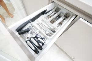 a drawer filled with knives and other kitchen utensils at Apartment Grace Royal in Vienna