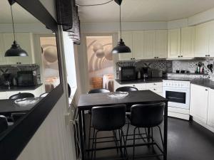 a kitchen with a table and chairs in it at Comfortable apartment in Nyköping